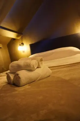 a hotel room with two beds with towels on them at Spa&Chill in Seraing