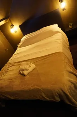 a white towel laying on a bed in a room at Spa&Chill in Seraing