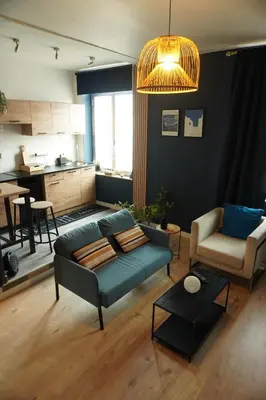 a living room with a couch and a table at ChambreNchill in Seraing