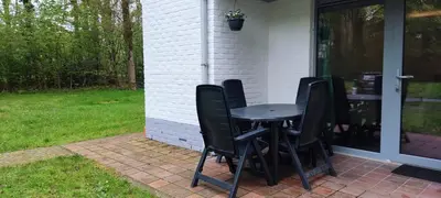 a table and chairs sitting on a patio at Vakantiebungalow BERK 1 in Houthalen-Helchteren