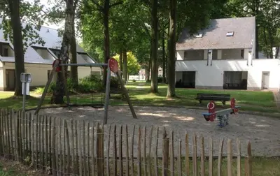 a playground with a swing set in a park at Vakantiebungalow BERK 1 in Houthalen-Helchteren