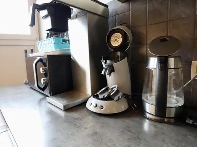 a kitchen counter with a coffee maker and a blender at Halinsart in Trooz