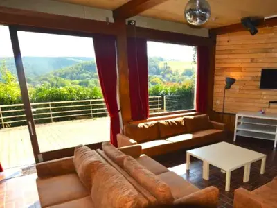 a living room with a couch and a large window at Halinsart in Trooz