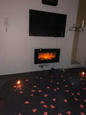 a living room with a fireplace with hearts on the floor at La home Gold Jacuzzi in Seraing
