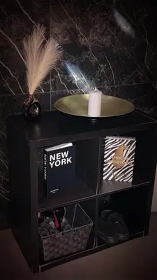 a black cabinet with a new york sign and a candle at La home Gold Jacuzzi in Seraing