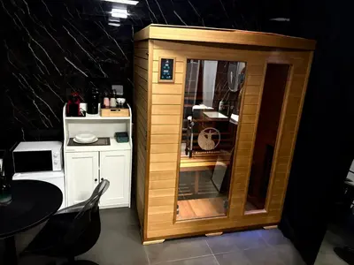 a small wooden cabinet in a kitchen with a table at La home Gold Jacuzzi in Seraing