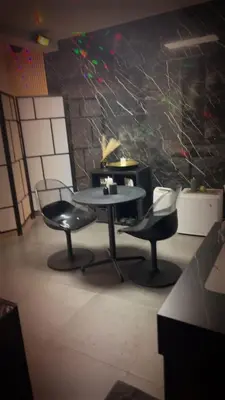 a table and two chairs in a room at La home Gold Jacuzzi in Seraing