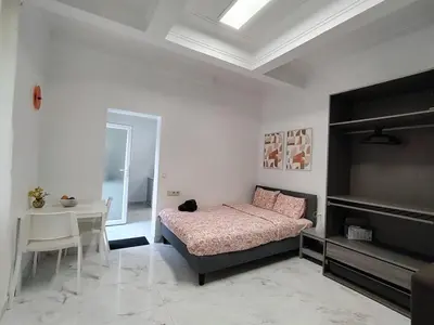 a bedroom with a bed and a table and a desk at Spacious, warm and cozy studio in Heers