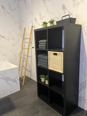 a black book shelf with potted plants and a ladder at GT Lounge Zolder in Heusden - Zolder
