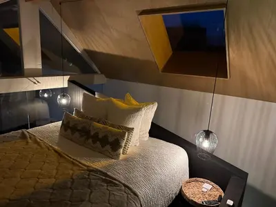 a bedroom with a bed with pillows and a table at Ô voda in Waremme