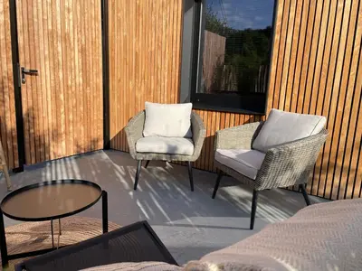 two chairs and a table on a patio at Ô voda in Waremme