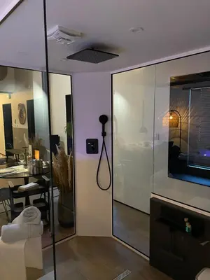 a room with a glass wall with a desk and a table at Ô voda in Waremme