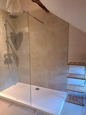 a shower with a glass door in a bathroom at Hoeve BôThé - Vakantiewoning in Alken