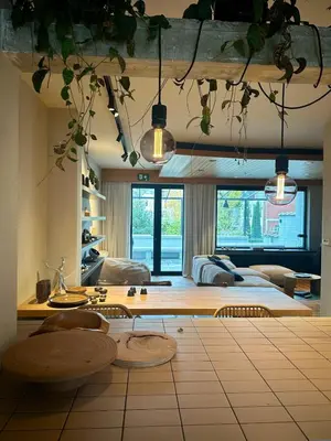 a living room with a bed and a table and chairs at Zalig HASPENGOUW in Sint-Truiden