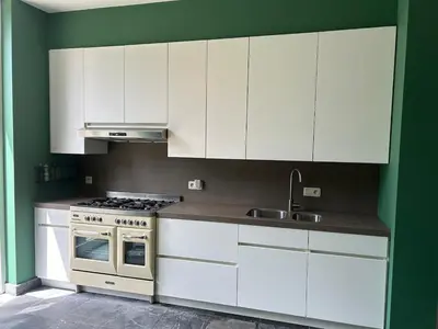 a kitchen with white cabinets and a stove at Vakantiehuis Twenty Six in Hasselt