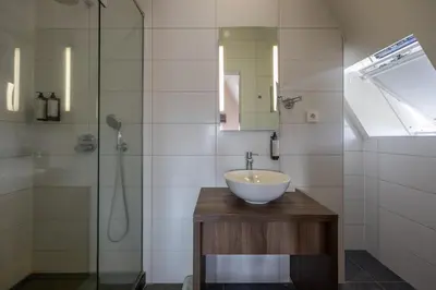a bathroom with a sink and a shower at Hotel De Boskar Pelt in Pelt