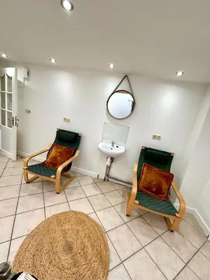 two chairs sitting in a room with a sink at Aux portes du marché in Verviers