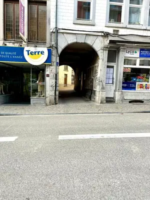 an entrance to a building with a tunnel in the street at Aux portes du marché in Verviers