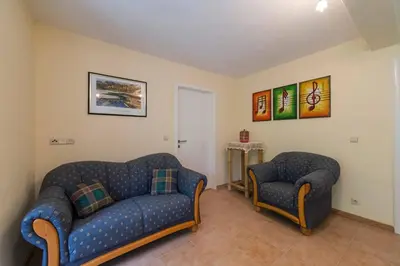 a living room with two couches and two chairs at Tweekamer Apartement in Dilsen-Stokkem
