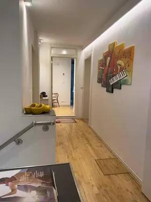 a room with a hallway with a painting on the wall at Tweekamer Apartement in Dilsen-Stokkem