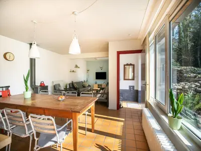 a dining room and living room with a table and chairs at Holiday Home in Lanklaar near Forest Trails in Lanklaar