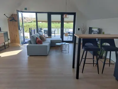 a living room with a couch and a table at L'Appart - New Appartement - Free Parking - Self Check-in - Terrasse in Eynatten