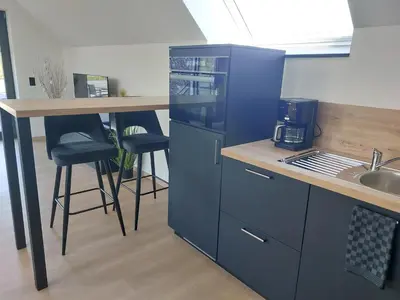 a blue kitchen with a counter and a sink at L'Appart - New Appartement - Free Parking - Self Check-in - Terrasse in Eynatten