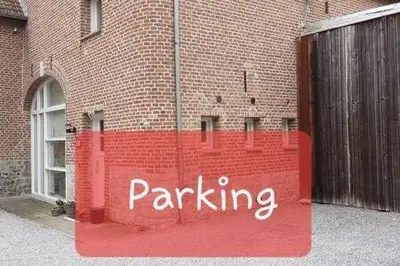 a parking sign on the side of a brick building at Take a break in Voeren