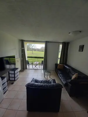 a living room with a couch and a table at Ap78 Nature Ardennes Economy class apartment in La Calamine