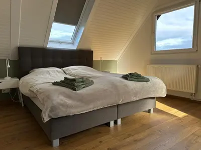 a bedroom with a bed with two towels on it at Raelax in Raeren