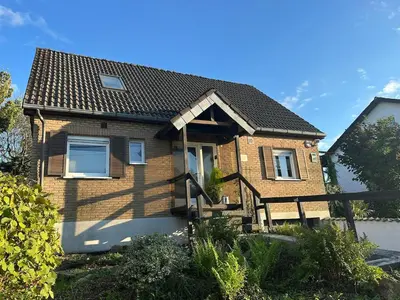 a brown brick house with a black roof at Raelax in Raeren