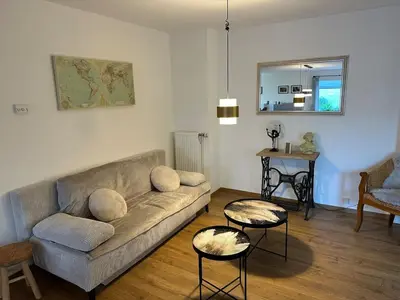 a living room with a couch and two tables at Raelax in Raeren