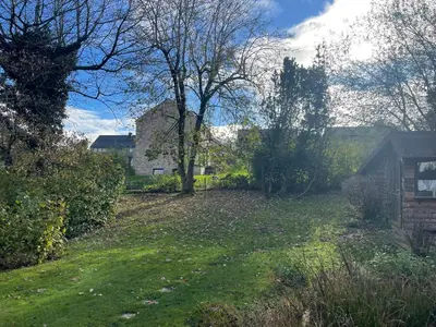 a yard with trees and a house in the background at Raelax in Raeren
