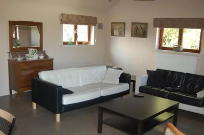 a living room with a white couch and a table at Alfonsinehoeve - we gaan zelf niet op vakantie, de vakantie komt naar ons in Heers