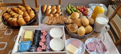 a table with various types of bread and other foods at Alfonsinehoeve - we gaan zelf niet op vakantie, de vakantie komt naar ons in Heers