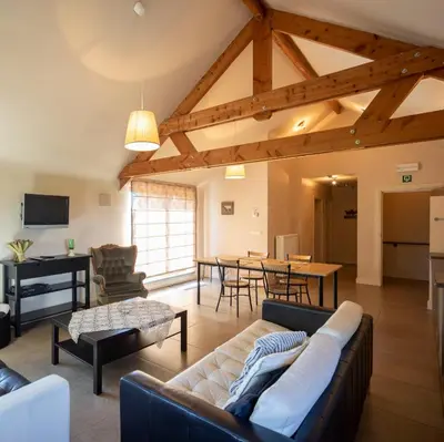 a living room with a couch and a table at Alfonsinehoeve - we gaan zelf niet op vakantie, de vakantie komt naar ons in Heers