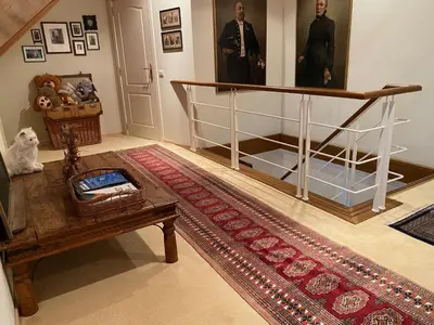 a living room with a table and a stair case at Nachtegaal in Dilsen-Stokkem