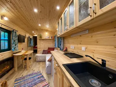 a kitchen and living room in a tiny house at Pipowagen Harambé in Lanaken