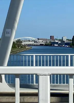 a bridge over a river with a bridge in the background at Hasselita in Hasselt