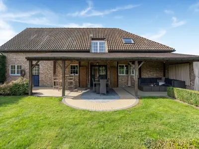 a house with a pavilion in a yard at Farmhouse including studio with Garden in Alken
