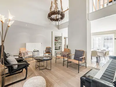 a living room with chairs and a table at Farmhouse including studio with Garden in Alken