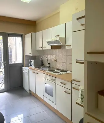 a kitchen with white cabinets and a stove top oven at Comfortable stay in Tongeren in Tongeren