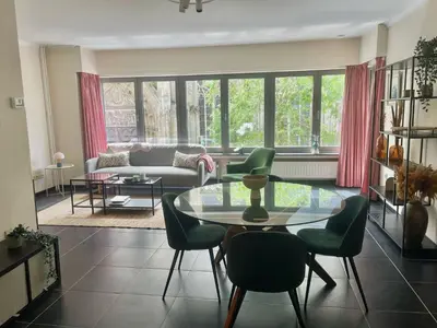 a living room with a glass table and chairs at Comfortable stay in Tongeren in Tongeren
