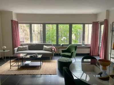 a living room with a couch and chairs and windows at Comfortable stay in Tongeren in Tongeren