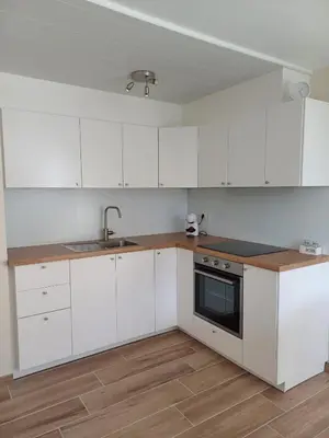 a white kitchen with white cabinets and a sink at Sunny and bright apartment Kelmis La Calamine Neu Moresnet in La Calamine