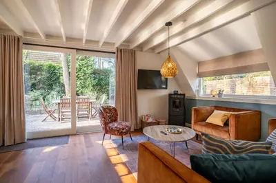a living room with a couch and a table at Boshuisje Rekem - Azure in Lanaken