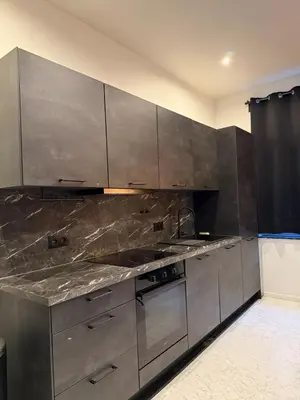 a kitchen with stainless steel cabinets and appliances at Magnifique appartement moderne in Liège