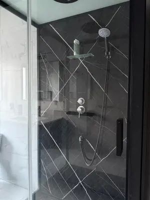 a shower with a glass door in a bathroom at Magnifique appartement moderne in Liège