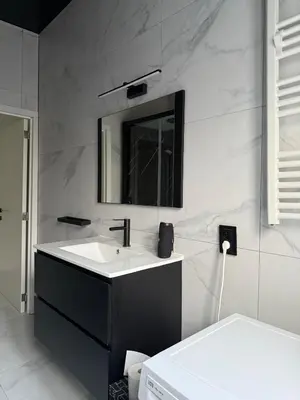 a bathroom with a sink and a mirror at Magnifique appartement moderne in Liège
