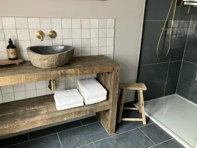 a bathroom with a sink and a shower at Huisje Emma in Tongeren